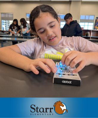  student working with ozobot robot and coding